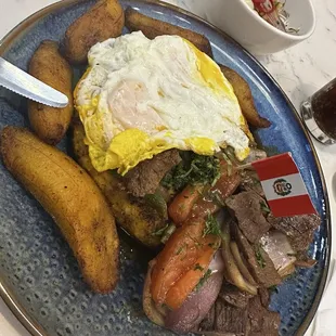Tacu Tacu con Lomo Saltado + eggs and plantains