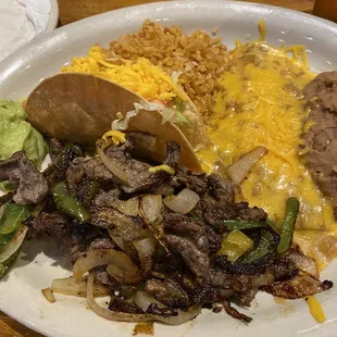 Tampiqueno plate, fajitas, taco, enchilada, guacamole, rice beans