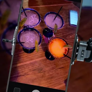 a person taking a picture of a drink