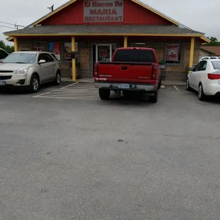 two cars parked in front of a restaurant