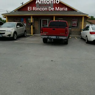 two cars parked in front of a restaurant