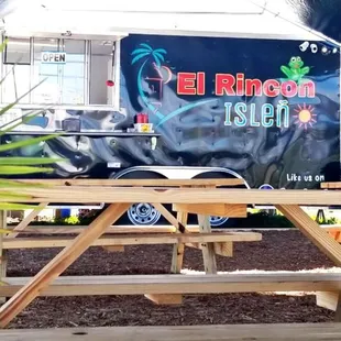 a picnic table and a food truck