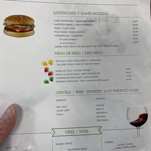 a hand holding a menu