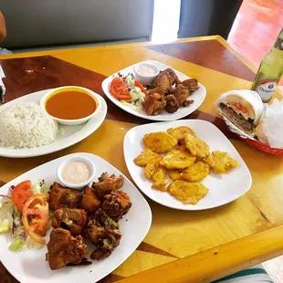 Chicharron de pollo, chimi, tostones and red beans and rice