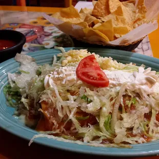 Burritos! Smothered in lettuce, sour cream, and cheese.