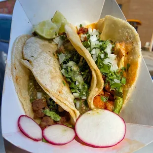 a hand holding a taco