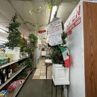 a grocery store with a sign hanging from the ceiling