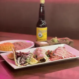 a plate of food and a bottle of beer