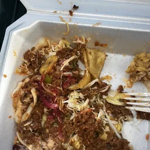 a close up of a food dish in a styrofoam container
