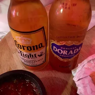 two bottles of beer and a hot dog