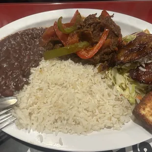 Shredded Beef, rice, beans, plantains, fried cheese and cabbage salad.