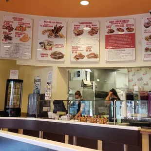 Menu above the counter in Spanish and English.