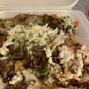 a plate of food in a styrofoam container