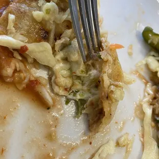 The inside of the pork, cheese and Loroco pupusa. The green stuff is the Loroco blossom