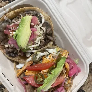 two tacos in a styrofoam container