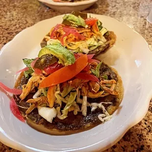 Panuchos de pollo!  Top notch!  Topped off with lettuce,cabbage,tomato,onion,jalapeño!