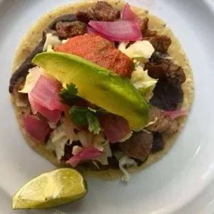 Tacos de Puc-Chuc! Mayan style.  Topped off with beans, cabbage, onions, tomato sauce, and lastly avocado!