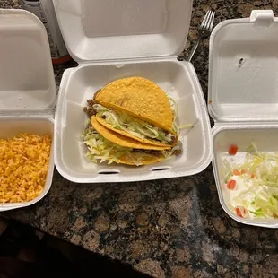 Three hard tacos and rice with pico.