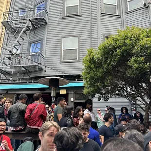 a crowd of people standing outside of a building