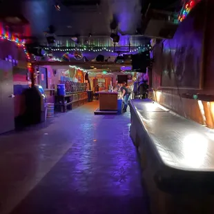 the interior of a bar with lights on