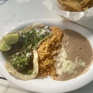 Carne Asada tacos, with rice and beans.