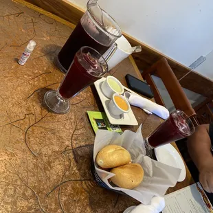 a person sitting at a table with food and drinks