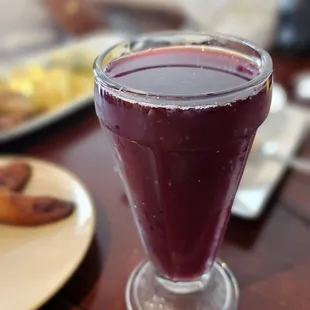 a glass of fruit juice on a table