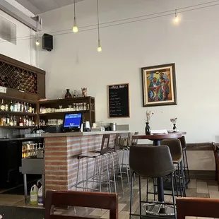 a view of a bar with chairs