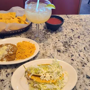 2 tacos, rice and beans, chips, salsa, and margarita.