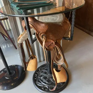 a saddled horse on a glass table