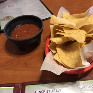a basket of chips and a bowl of salsa
