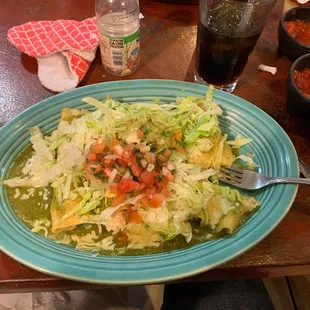 a plate of salad and a drink on a table