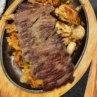 a steak and vegetables in a skillet