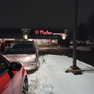 cars parked in a parking lot at night