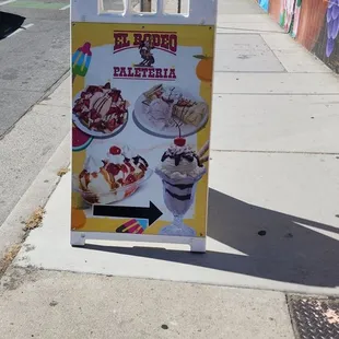 a sign on a sidewalk