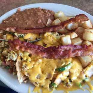 Migas with cheese added bacon! I got corn tortillas on the side and they were super tasty!