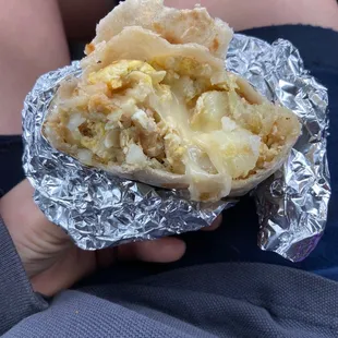 a person holding a burrito