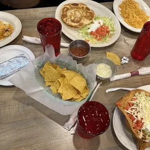 a table of mexican food and drinks