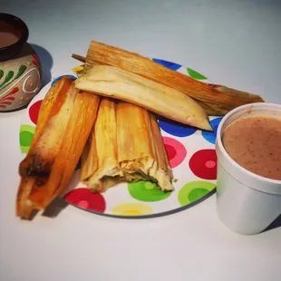 a plate of tamales and a cup of coffee