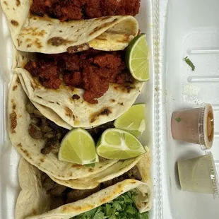 Spicy Pork and Steak Tacos on Flour Tortilla with sauce sides