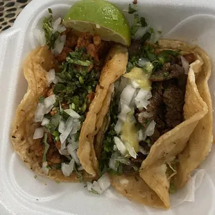 two tacos in a styrofoam container