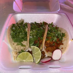 Three tacos. Chicken. Pastor. Chorizo.