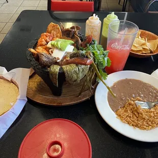 Molcajete, hand made tortillas and rice and beans, with strawberry lemonade
