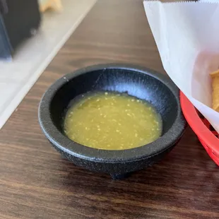 a bowl of soup and a basket of bread