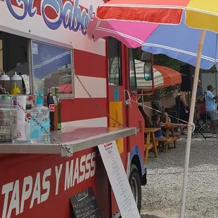 a food truck with a colorful umbrella