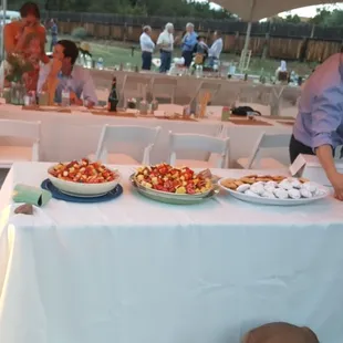 a man serving food to a woman
