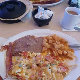 Chilequilles Regulares (delicious), beans, papas (comes with Ranchero sauce on top), my husband's bacon, coffee, and HUGE tortillas.