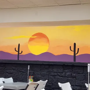 a desert scene painted on a wall