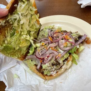 Torta asada with everything (avocado, beans, white cheese, lettuce) **i added purple onions with habanero and lime