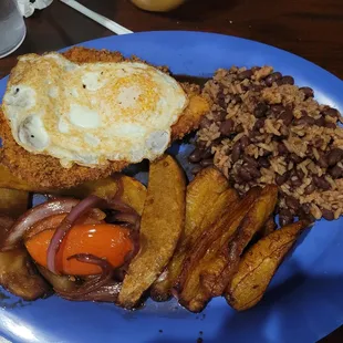 Chicken with an egg on top, Plantains and beans and rice.